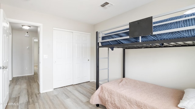 bedroom featuring a closet and light wood-type flooring