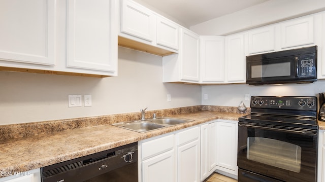 kitchen featuring black appliances, sink, and white cabinets