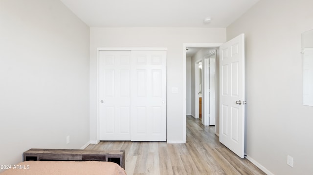 bedroom featuring a closet and light hardwood / wood-style floors