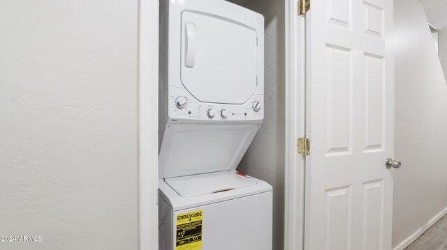 laundry area with stacked washer / dryer