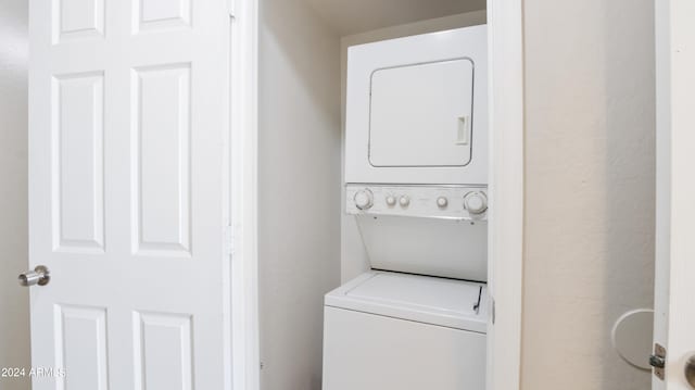 laundry area with stacked washer / drying machine