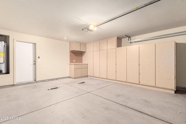 garage featuring a garage door opener and water heater