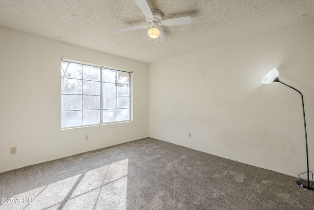 spare room featuring a textured ceiling, carpet, and a ceiling fan