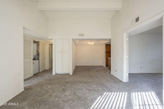 spare room featuring a notable chandelier, beamed ceiling, and visible vents