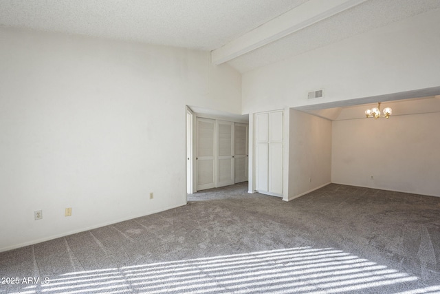 unfurnished bedroom featuring lofted ceiling with beams, a textured ceiling, carpet floors, visible vents, and an inviting chandelier