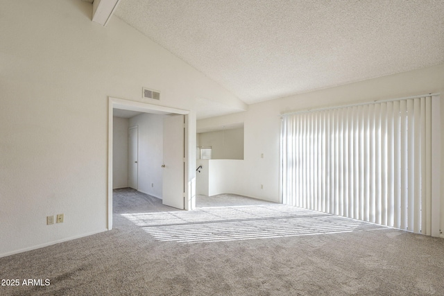 interior space featuring light carpet, high vaulted ceiling, a textured ceiling, and visible vents