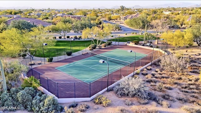 view of sport court featuring a lawn