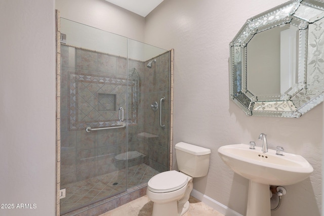 bathroom with toilet, an enclosed shower, and sink