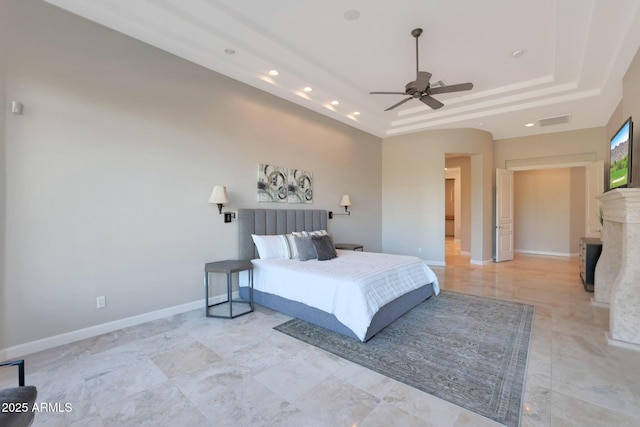 bedroom featuring a raised ceiling and ceiling fan