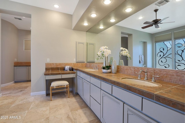 bathroom featuring decorative backsplash, vanity, and ceiling fan