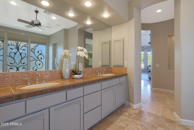 bathroom with vanity, ceiling fan, and tasteful backsplash