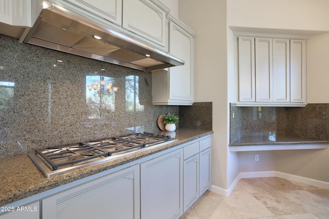 kitchen featuring tasteful backsplash, white cabinetry, light tile patterned floors, and stainless steel gas cooktop