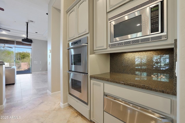 kitchen with hanging light fixtures, crown molding, decorative backsplash, dark stone countertops, and appliances with stainless steel finishes