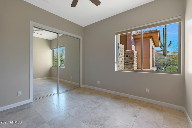 unfurnished bedroom featuring a closet and ceiling fan