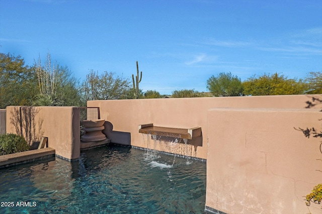 view of swimming pool featuring pool water feature