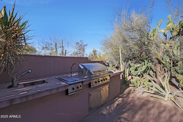 view of patio / terrace with sink, an outdoor kitchen, and a grill