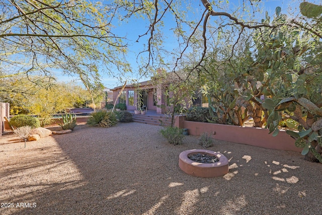 view of yard featuring an outdoor fire pit