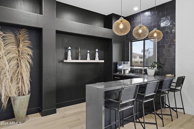 interior space featuring light wood-type flooring and decorative light fixtures