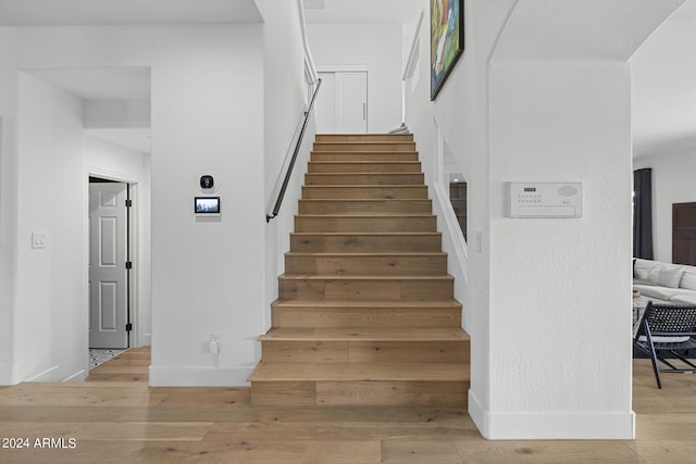 stairway featuring hardwood / wood-style flooring