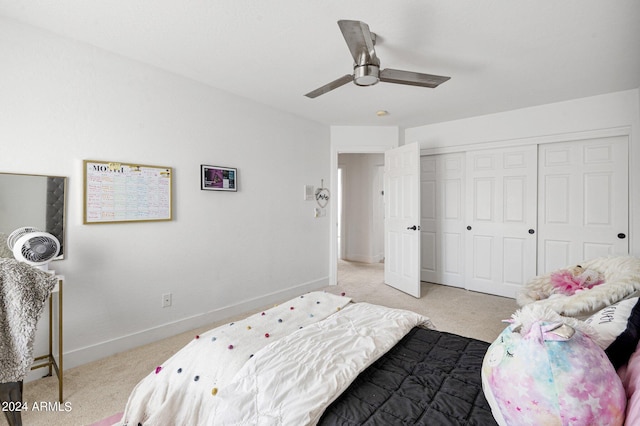 carpeted bedroom featuring ceiling fan and a closet