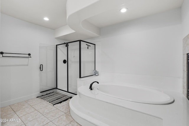 bathroom with independent shower and bath and tile patterned floors