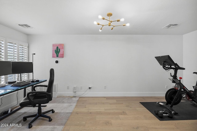 office area with a chandelier and light hardwood / wood-style floors