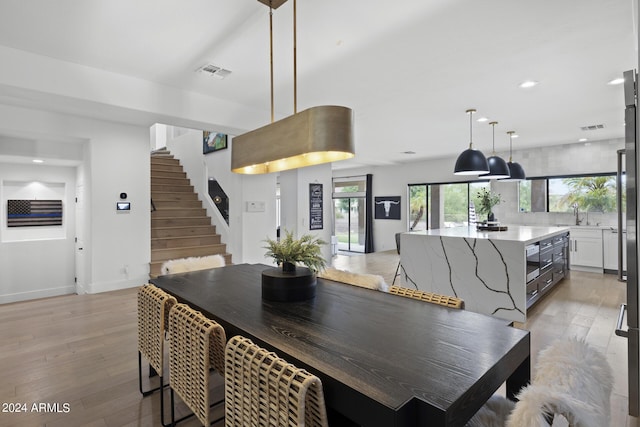 dining room featuring sink and light wood-type flooring