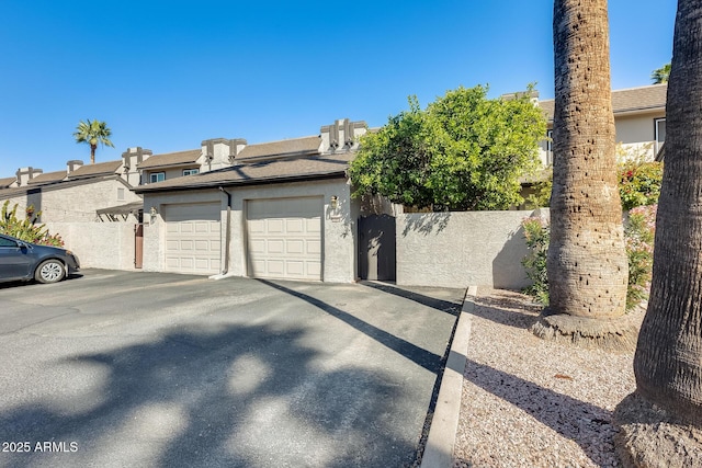 view of side of home with fence and stucco siding