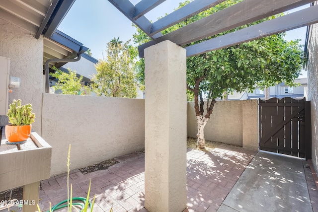 view of patio with a gate and fence