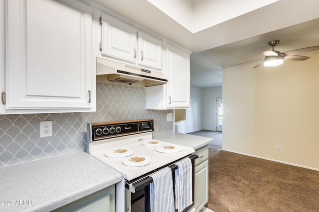 kitchen with under cabinet range hood, carpet flooring, white electric range oven, and light countertops