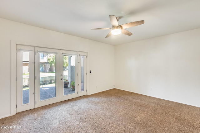 carpeted spare room featuring french doors, baseboards, and ceiling fan