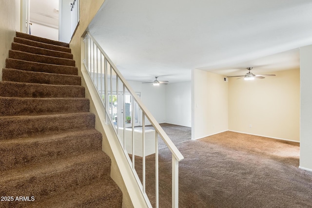 staircase featuring carpet flooring, baseboards, and a ceiling fan