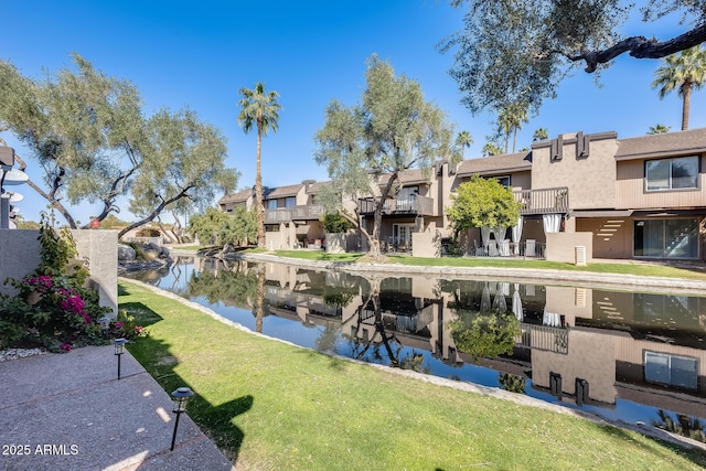 exterior space featuring a residential view and a water view