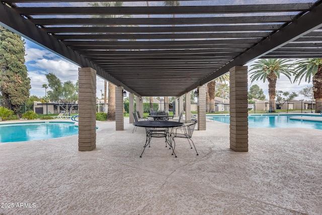 community pool featuring a patio and fence