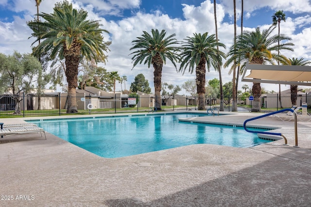 pool featuring fence and a patio area