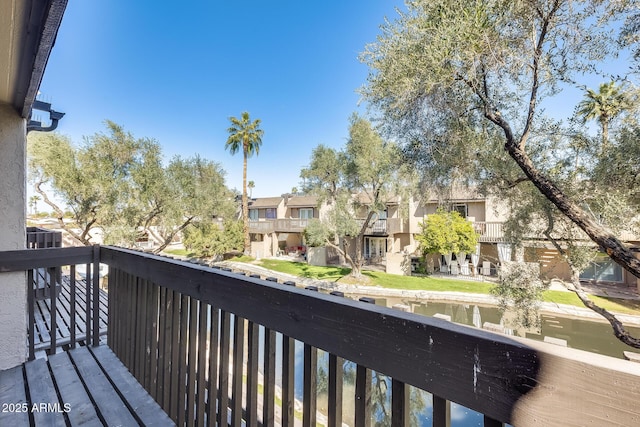 balcony with a residential view and a water view