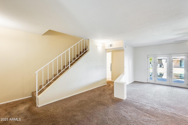 interior space with visible vents, baseboards, and carpet