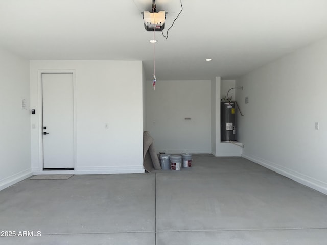 garage featuring water heater, baseboards, and a garage door opener