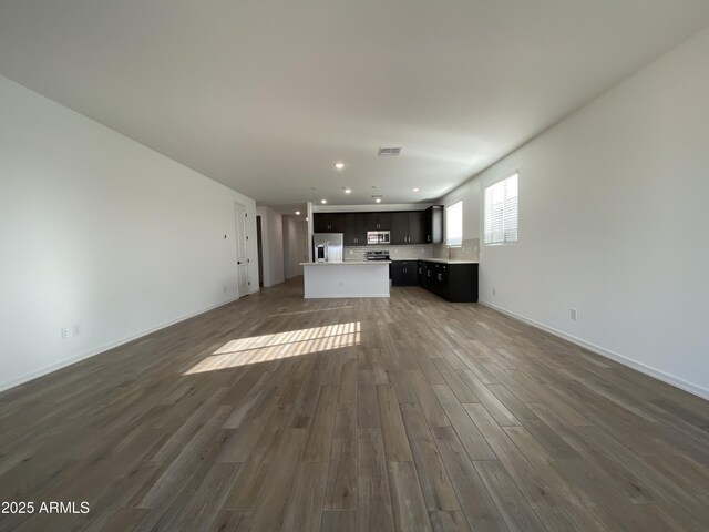 unfurnished living room featuring dark wood-style floors, recessed lighting, visible vents, and baseboards