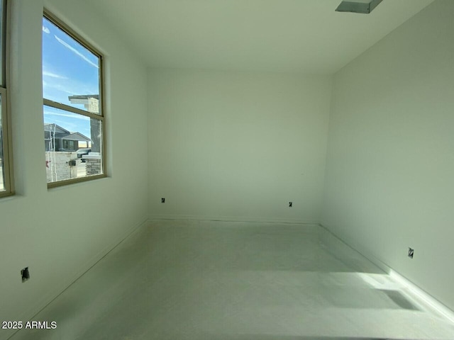 spare room with concrete floors