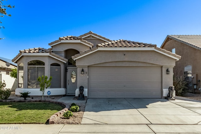 mediterranean / spanish home featuring a garage