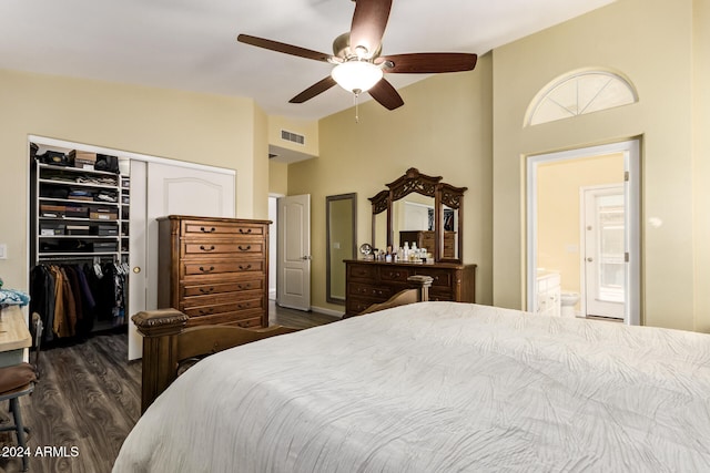 bedroom with connected bathroom, a closet, dark wood-type flooring, and ceiling fan