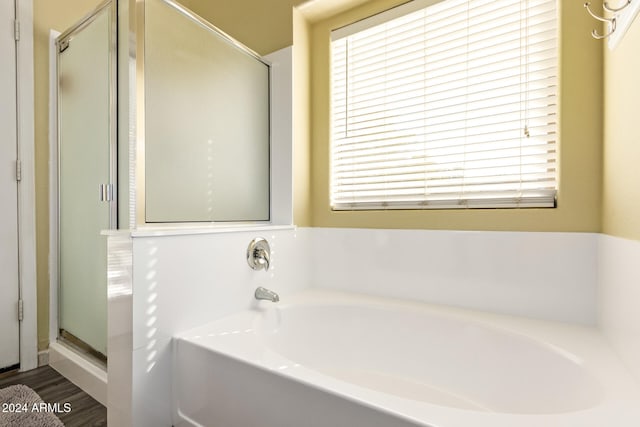 bathroom featuring independent shower and bath