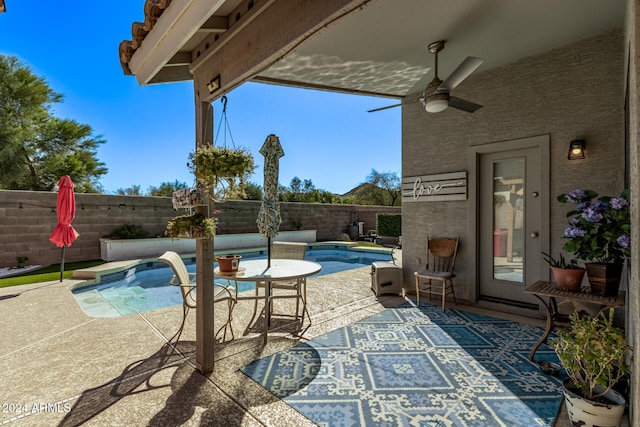 view of patio with ceiling fan and a fenced in pool