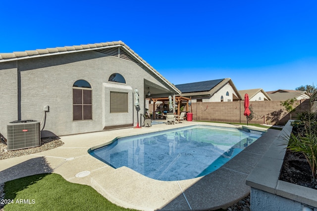 view of pool with central AC unit and a patio