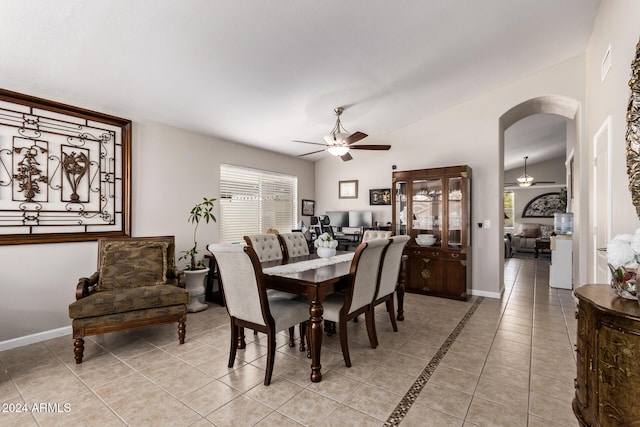 tiled dining area with vaulted ceiling and ceiling fan