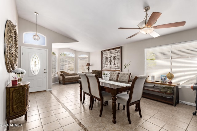 dining room with ceiling fan, plenty of natural light, light tile patterned flooring, and lofted ceiling