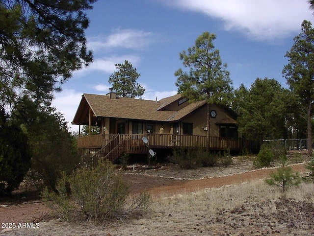 view of front of home featuring a deck and a chimney