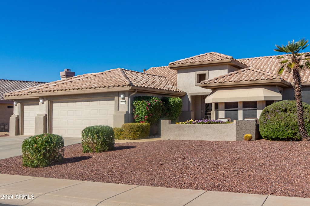 mediterranean / spanish-style home featuring a garage