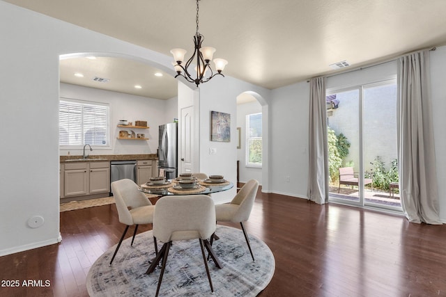 3863 S Posse Trl, Gilbert, AZ 85297 - dining space with arched walkways, dark wood-type flooring, a chandelier, and recessed lighting